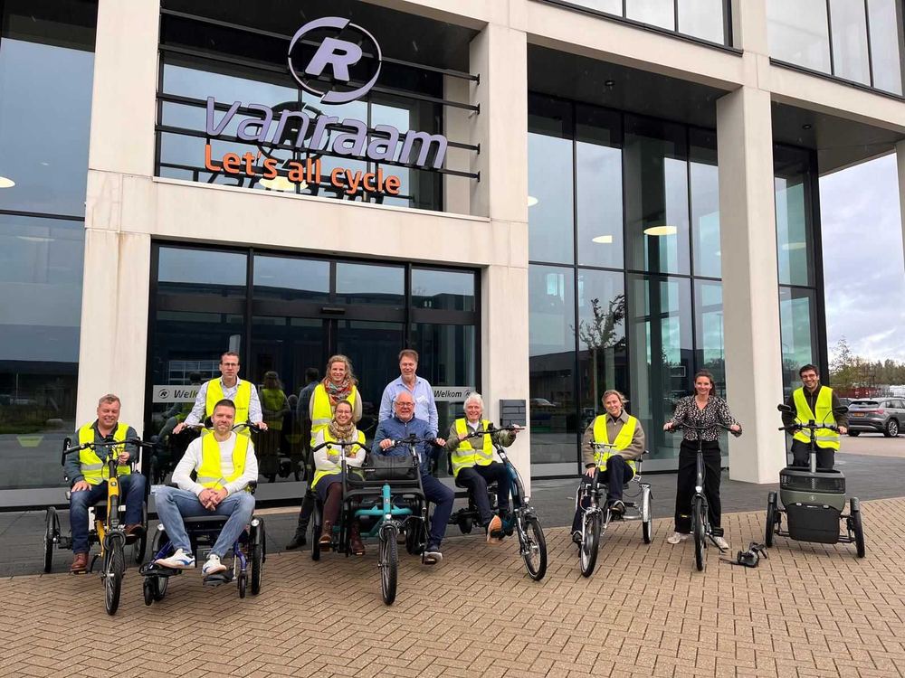 Members of the FITS consortium on adapted bikes outside the Van Raam factory during a partner meeting.